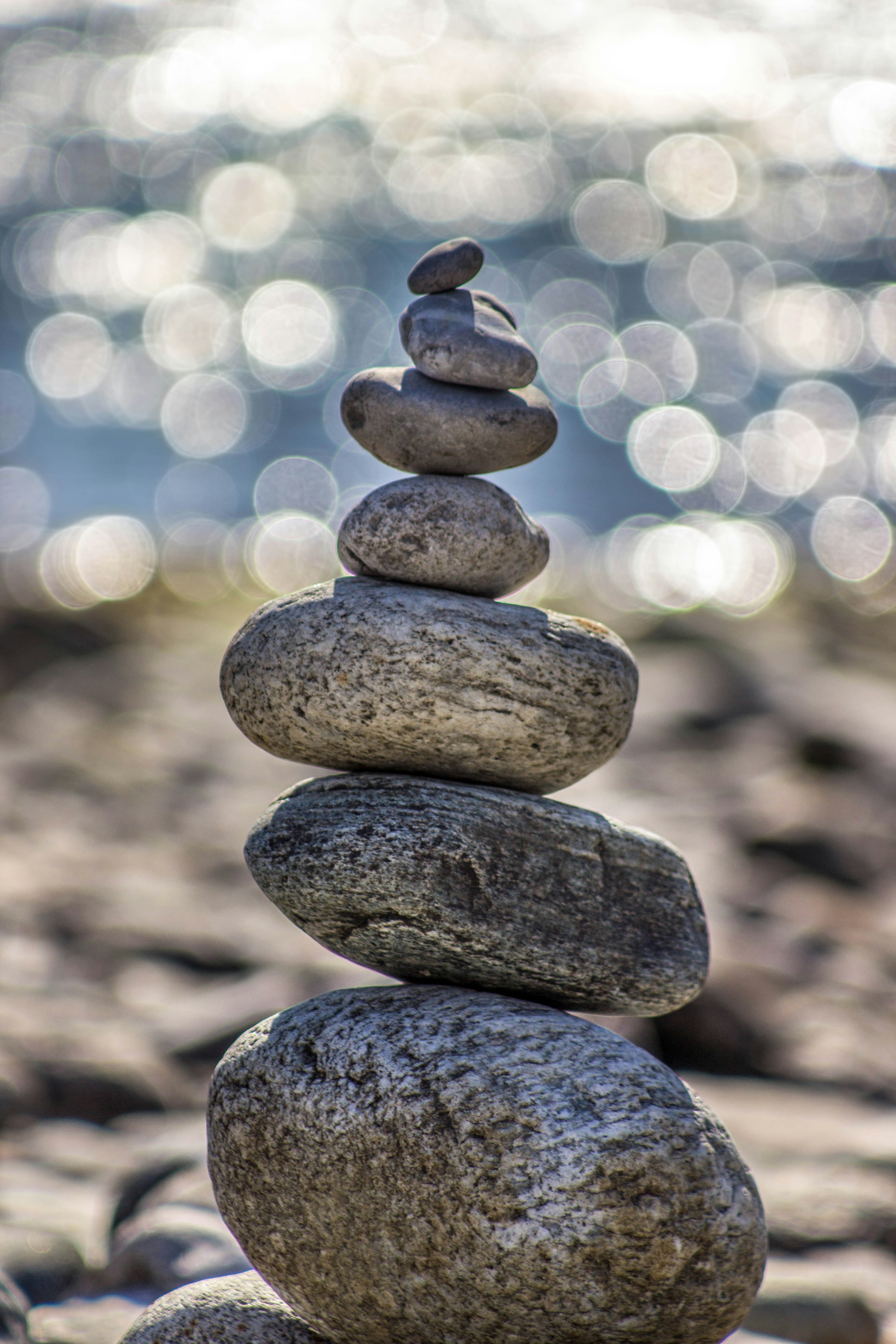 Rock tower on beach symbolizng peace and tranquility achieved from particpating in therapy at north shore professional therapy with Sarah Haugh, LMHC