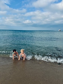 Two children play in the shorelines in MA, signifying finding our inner child at North Shore Professional Therapy. Daughters of Sarah Haugh, LMHC, Therapist