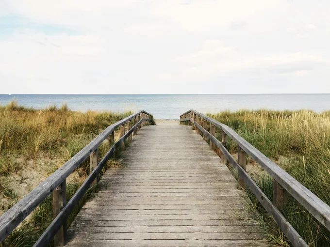 boardwalk to beach to represent healing, hope and peace after trauma therapy in mass or anxiety therapy in mass